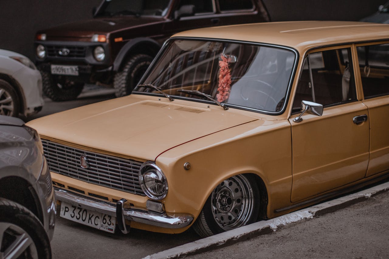 Classic vintage brown car parked in a city street with retro vibes.